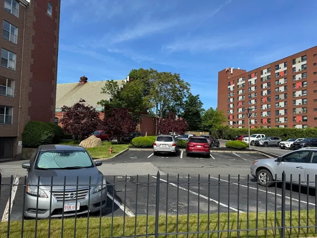a view of a cars park in front of a building