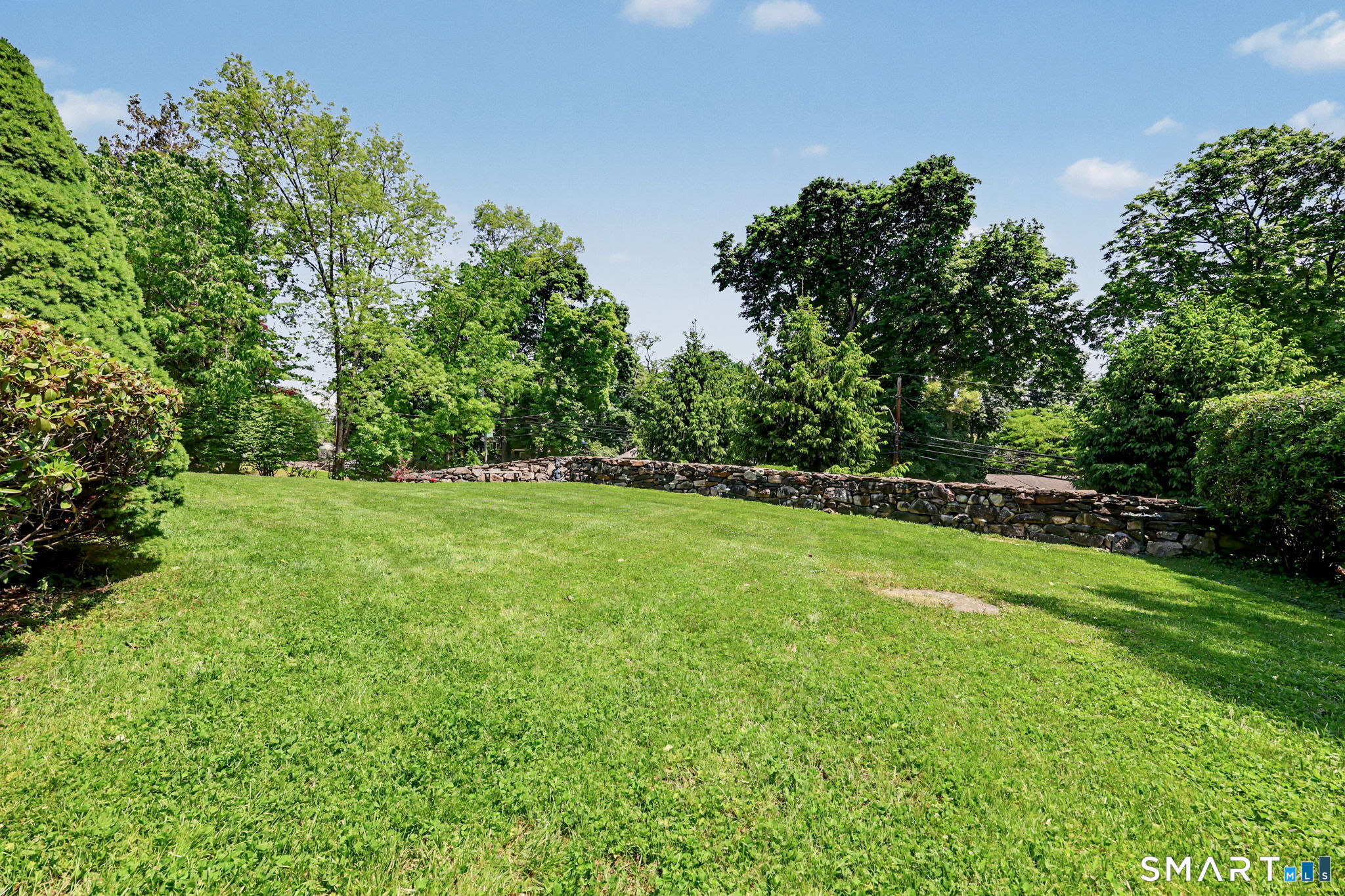 1100 Stillwater Road Stamford, CT 06902 - Photo 36 of 40 Private front yard with stone walls and mature plantings