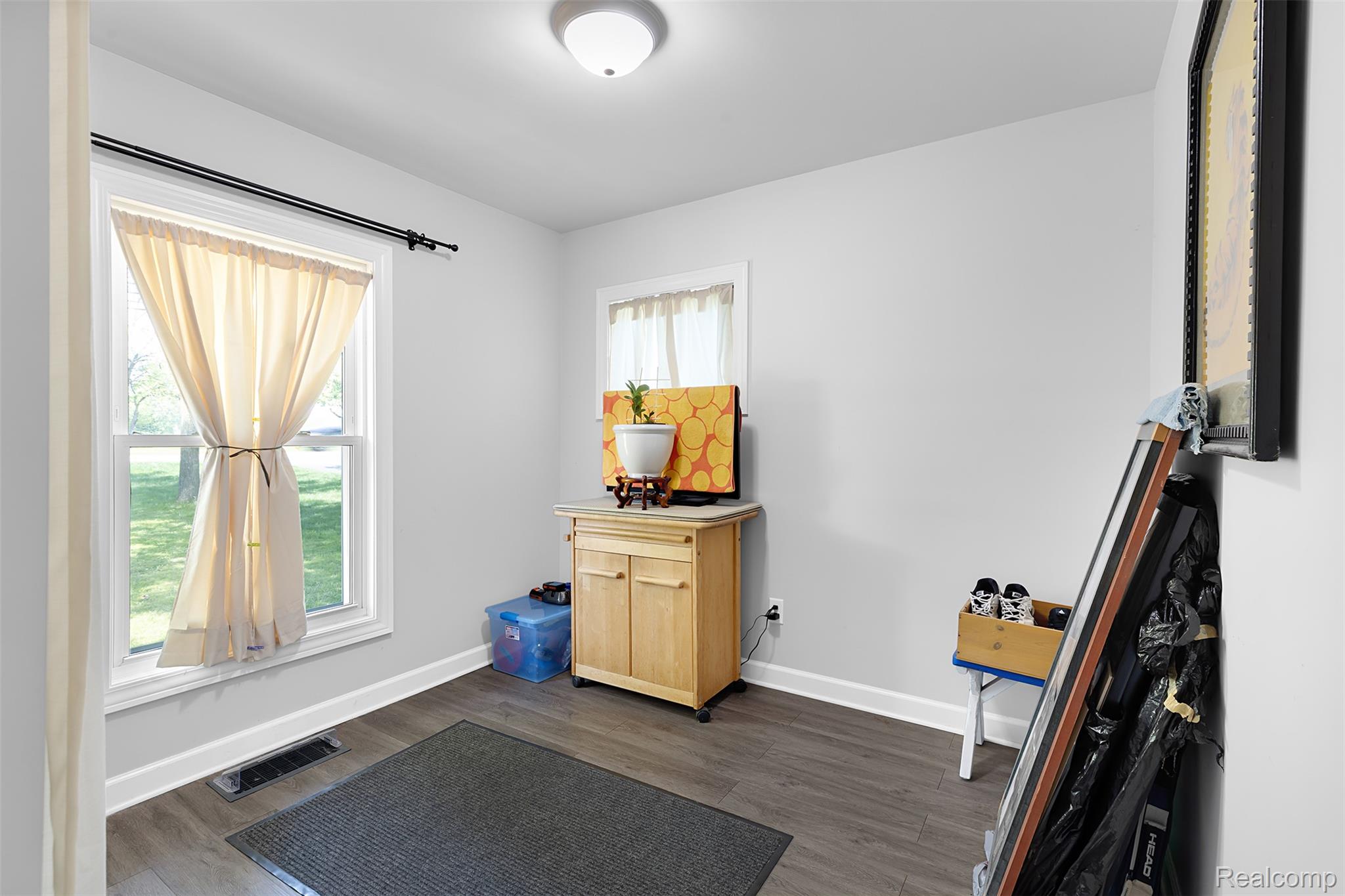 22827 Meridian Road Grosse Ile, MI 48138 - Photo 29 of 36 Workout room with dark wood-type flooring and baseboards