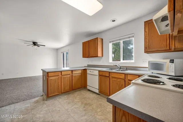 a kitchen with stainless steel appliances granite countertop a stove a sink dishwasher and a refrigerator