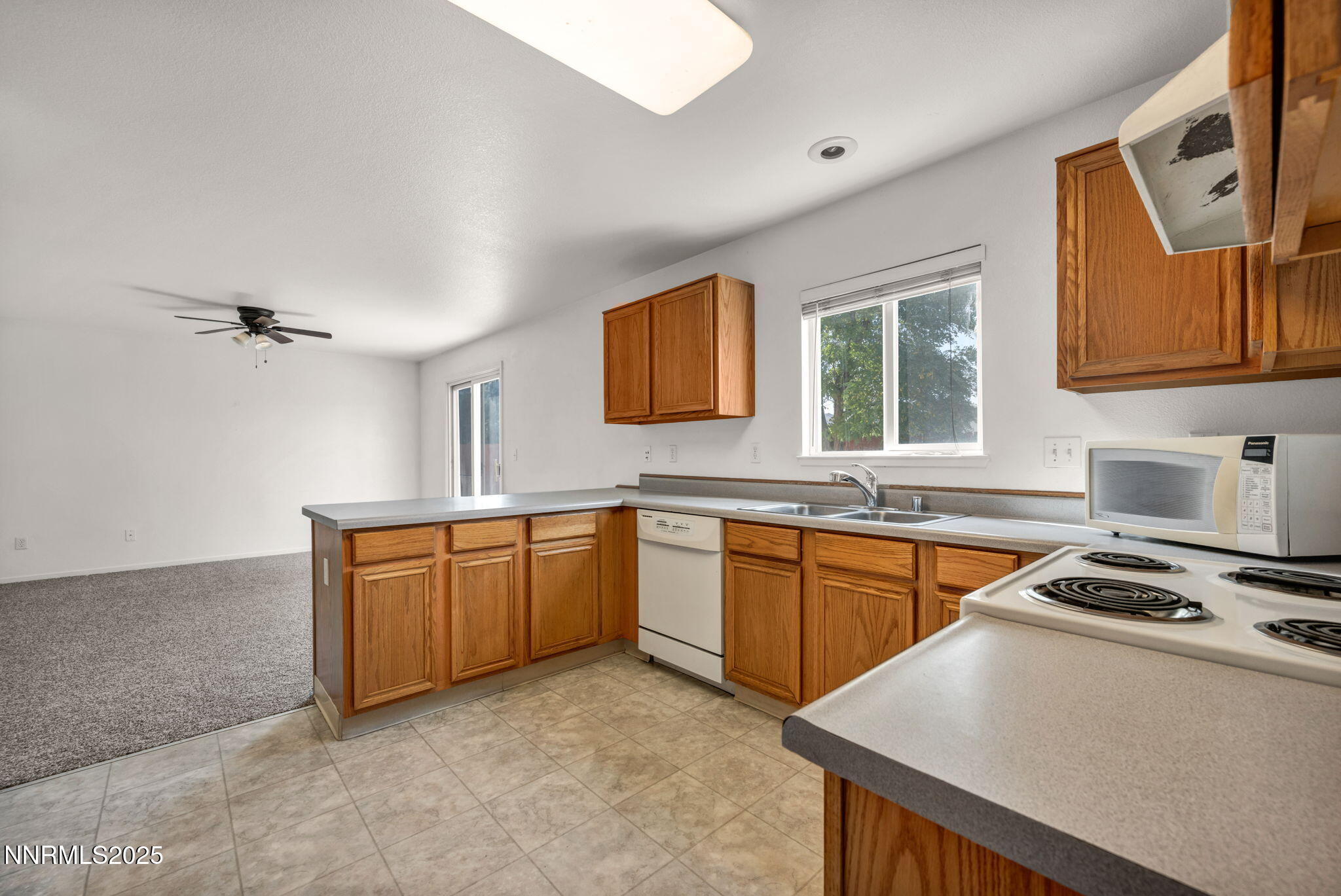 115 Calistoga Court Reno, NV 89508 - Photo 11 of 58 a kitchen with stainless steel appliances granite countertop a stove a sink dishwasher and a refrigerator
