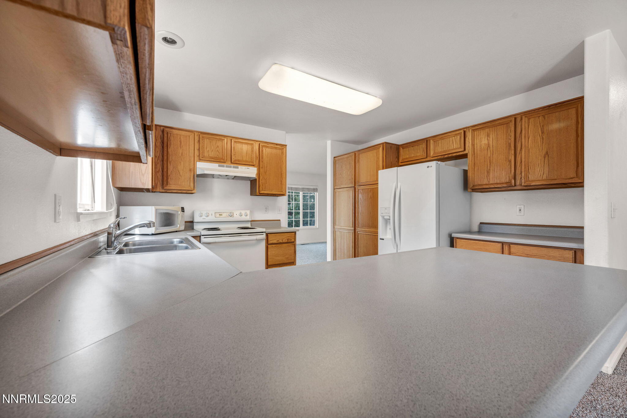 115 Calistoga Court Reno, NV 89508 - Photo 12 of 58 a kitchen with stainless steel appliances a refrigerator sink and cabinets