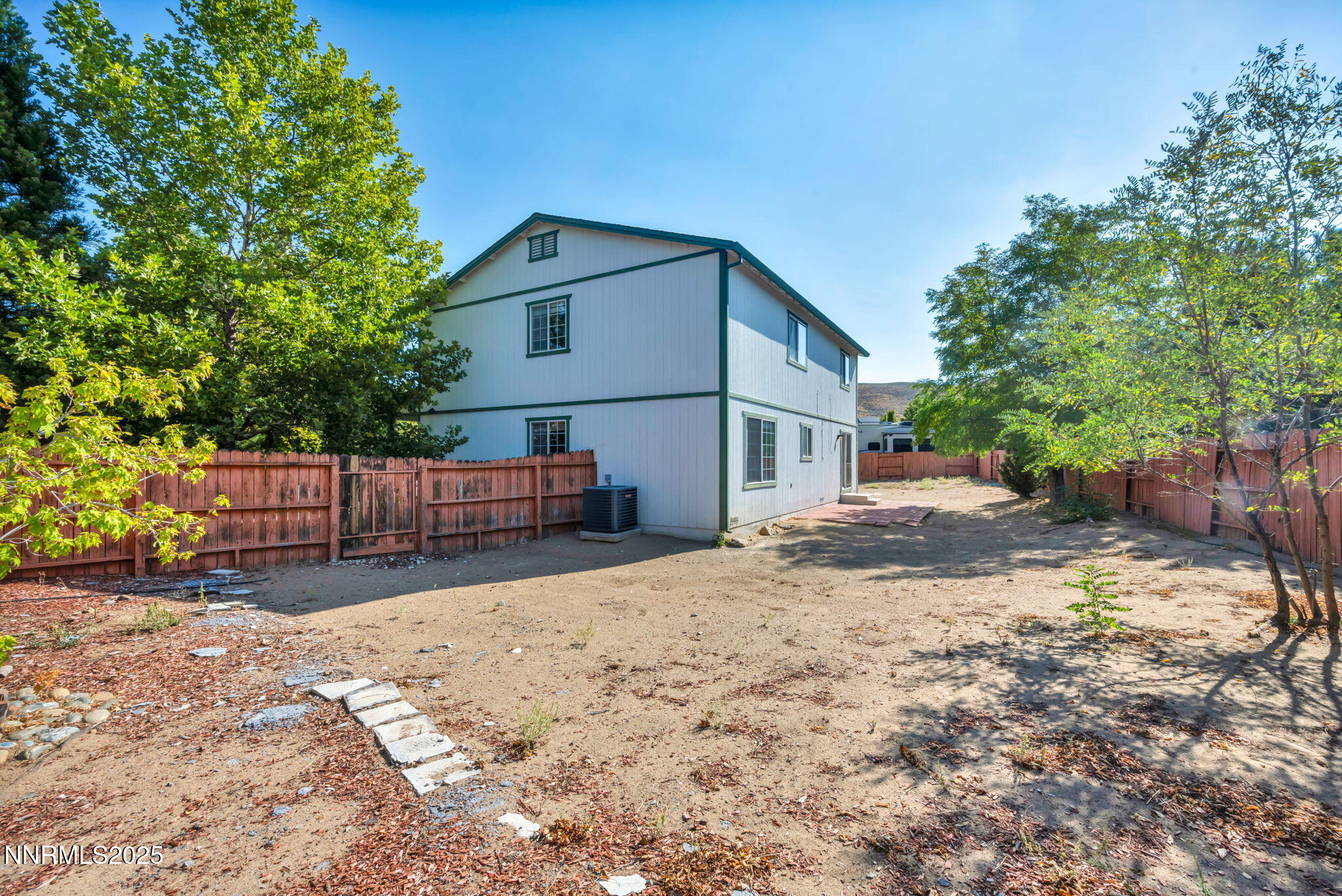115 Calistoga Court Reno, NV 89508 - Photo 42 of 58 a view of a house with wooden fence and trees