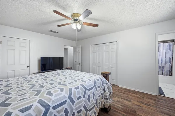 a bedroom with a bed and a chandelier
