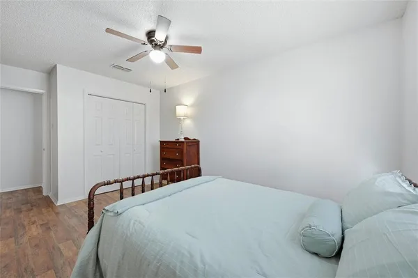 a bedroom with a bed and a ceiling fan