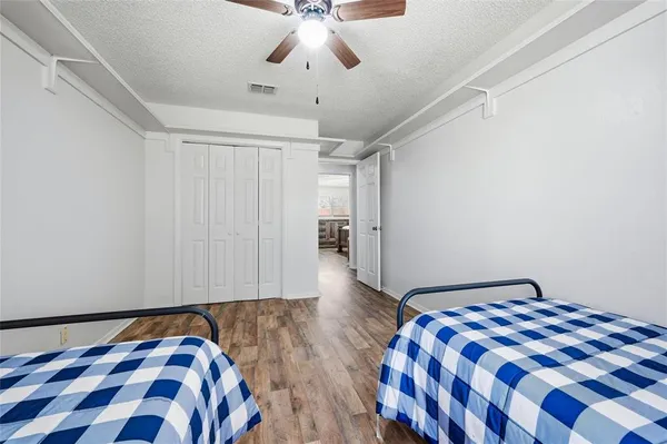 a bedroom with a bed and wooden floor