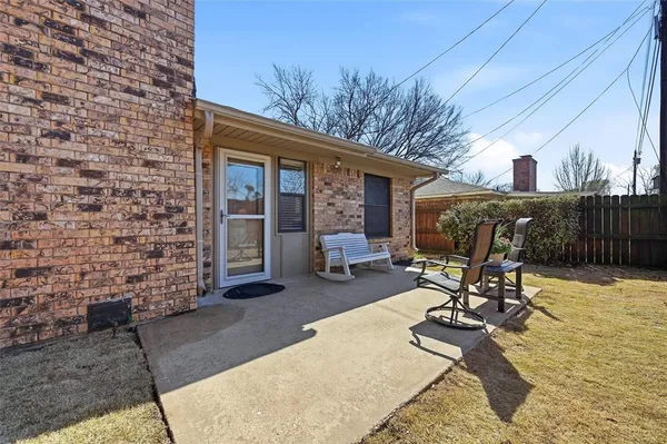a view of a porch with furniture and floor to ceiling window