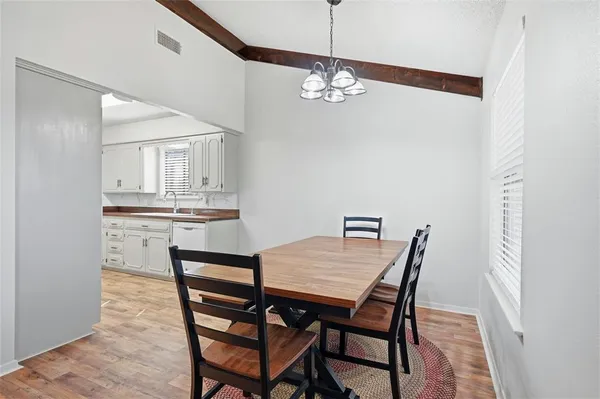 a view of a dining room with furniture and chandelier