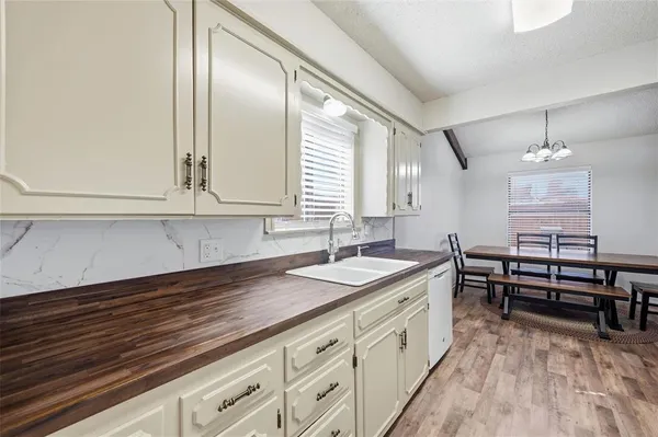 a spacious bathroom with a double vanity sink a mirror and a bathtub