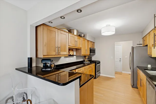 a kitchen with stainless steel appliances a sink and a stove