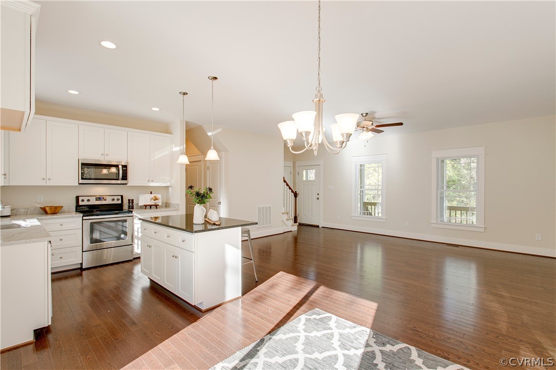 15812 Harrowgate Road Chester, VA 23831 - Photo 10 of 31 a large white kitchen with cabinets a sink and stainless steel appliances