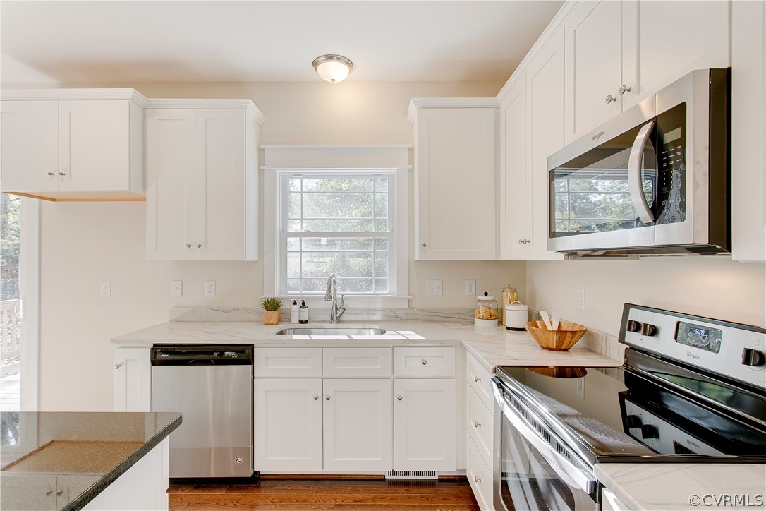 15812 Harrowgate Road Chester, VA 23831 - Photo 12 of 31 a kitchen with a sink stove and cabinets