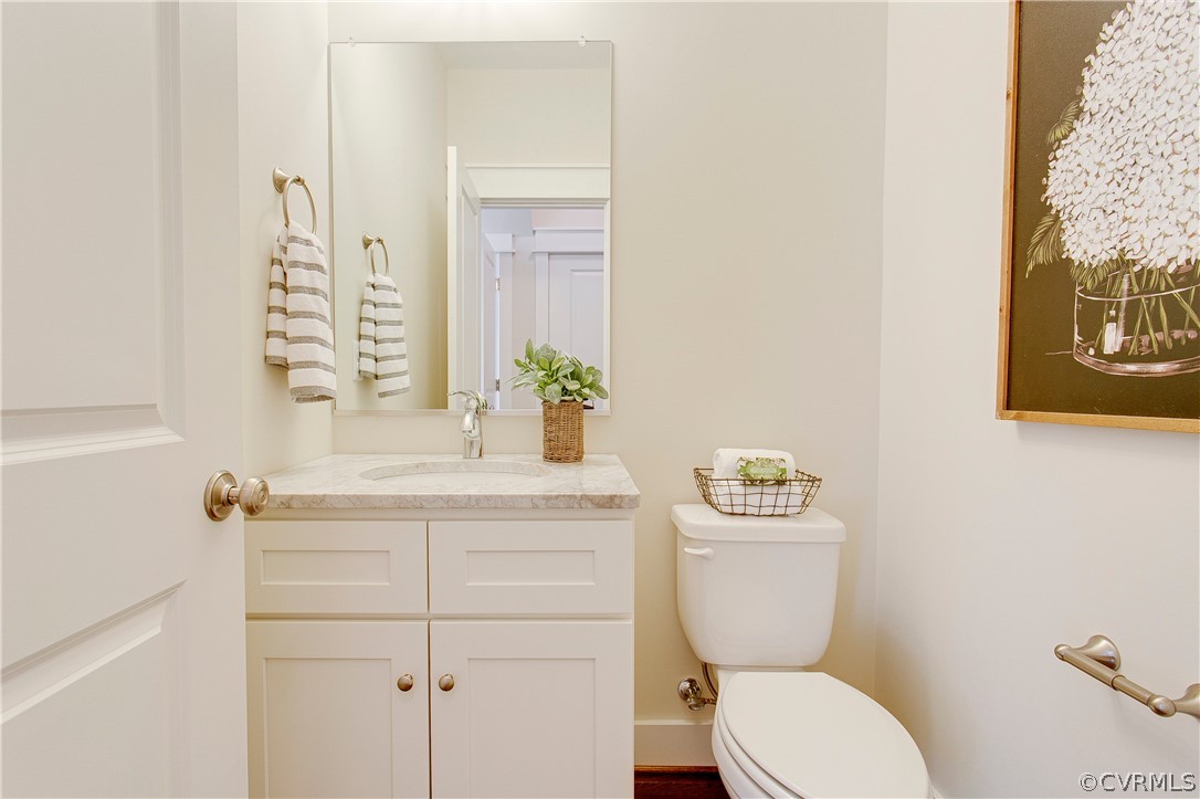 15812 Harrowgate Road Chester, VA 23831 - Photo 14 of 31 a bathroom with a toilet a sink and mirror