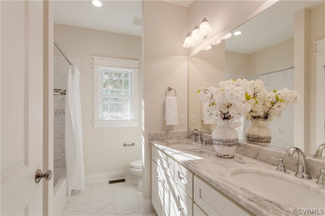 15812 Harrowgate Road Chester, VA 23831 - Photo 18 of 31 a bathroom with a granite countertop sink a toilet and a mirror
