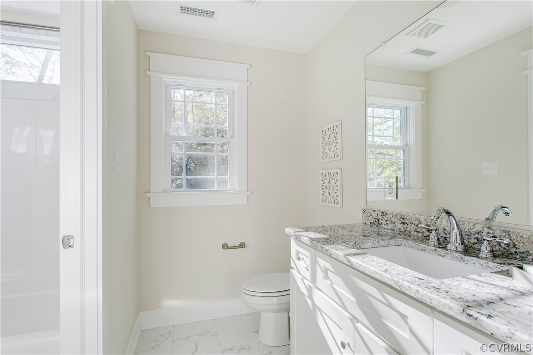 15812 Harrowgate Road Chester, VA 23831 - Photo 26 of 31 a bathroom with a granite countertop sink toilet and mirror
