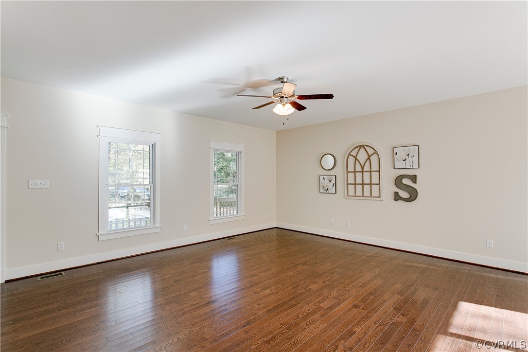 15812 Harrowgate Road Chester, VA 23831 - Photo 5 of 31 a view of an empty room with window and wooden floor