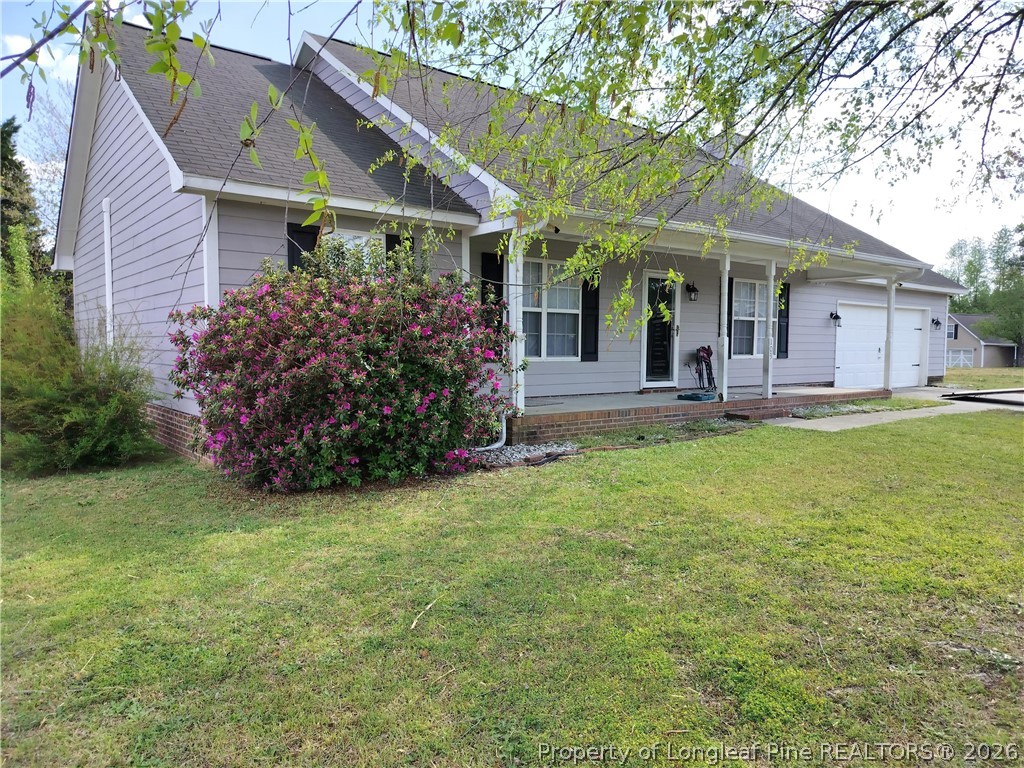 103 Kingsberry Court Raeford, NC 28376 - Photo 1 of 4 a front view of a house with garden