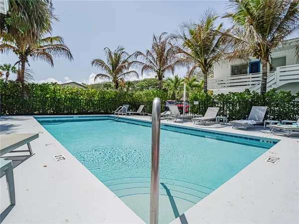 a view of a swimming pool with a table and chairs