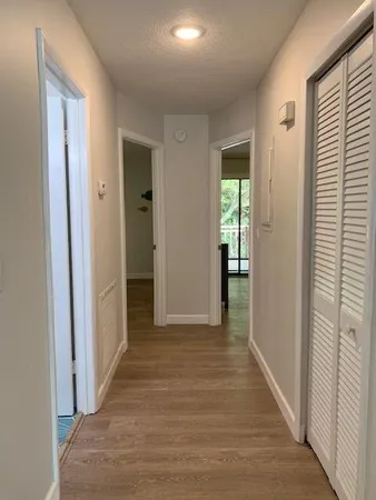 a view of hallway with wooden floor