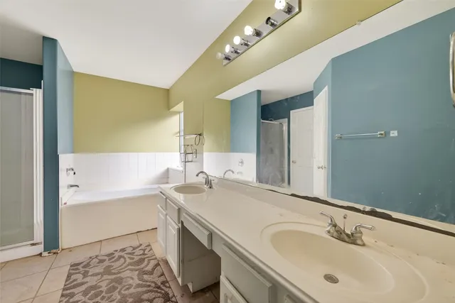 a bathroom with a tub sink and mirror