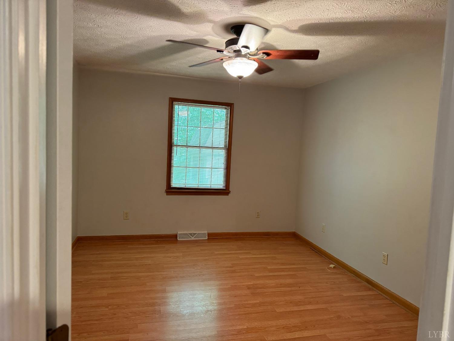 580 First Rock Road Prospect, VA 23960 - Photo 15 of 22 an empty room with a chandelier fan and windows