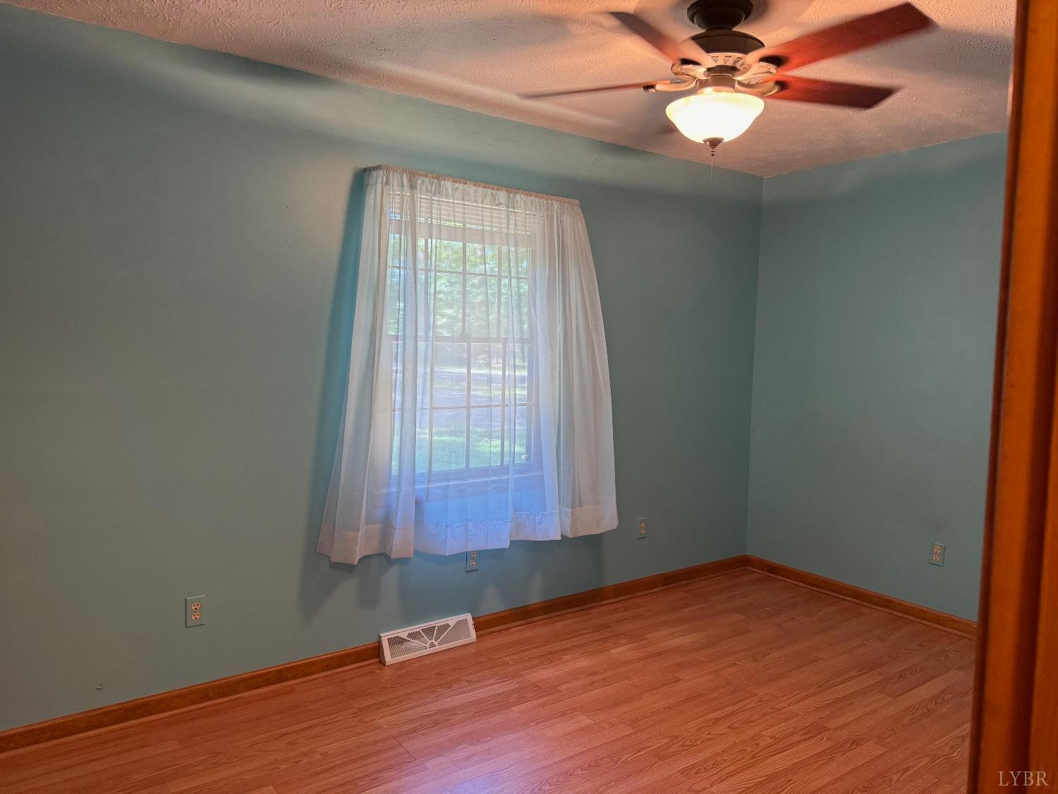 580 First Rock Road Prospect, VA 23960 - Photo 16 of 22 an empty room with wooden floor and windows