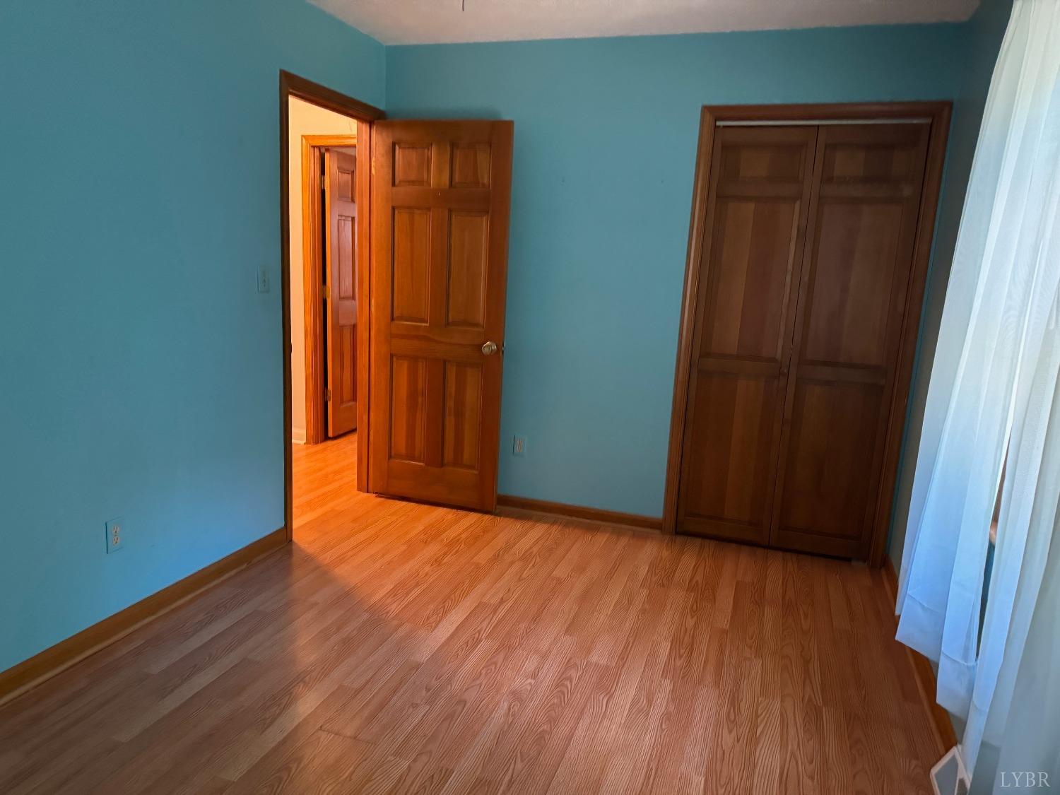580 First Rock Road Prospect, VA 23960 - Photo 17 of 22 a view of an empty room with wooden floor and a window