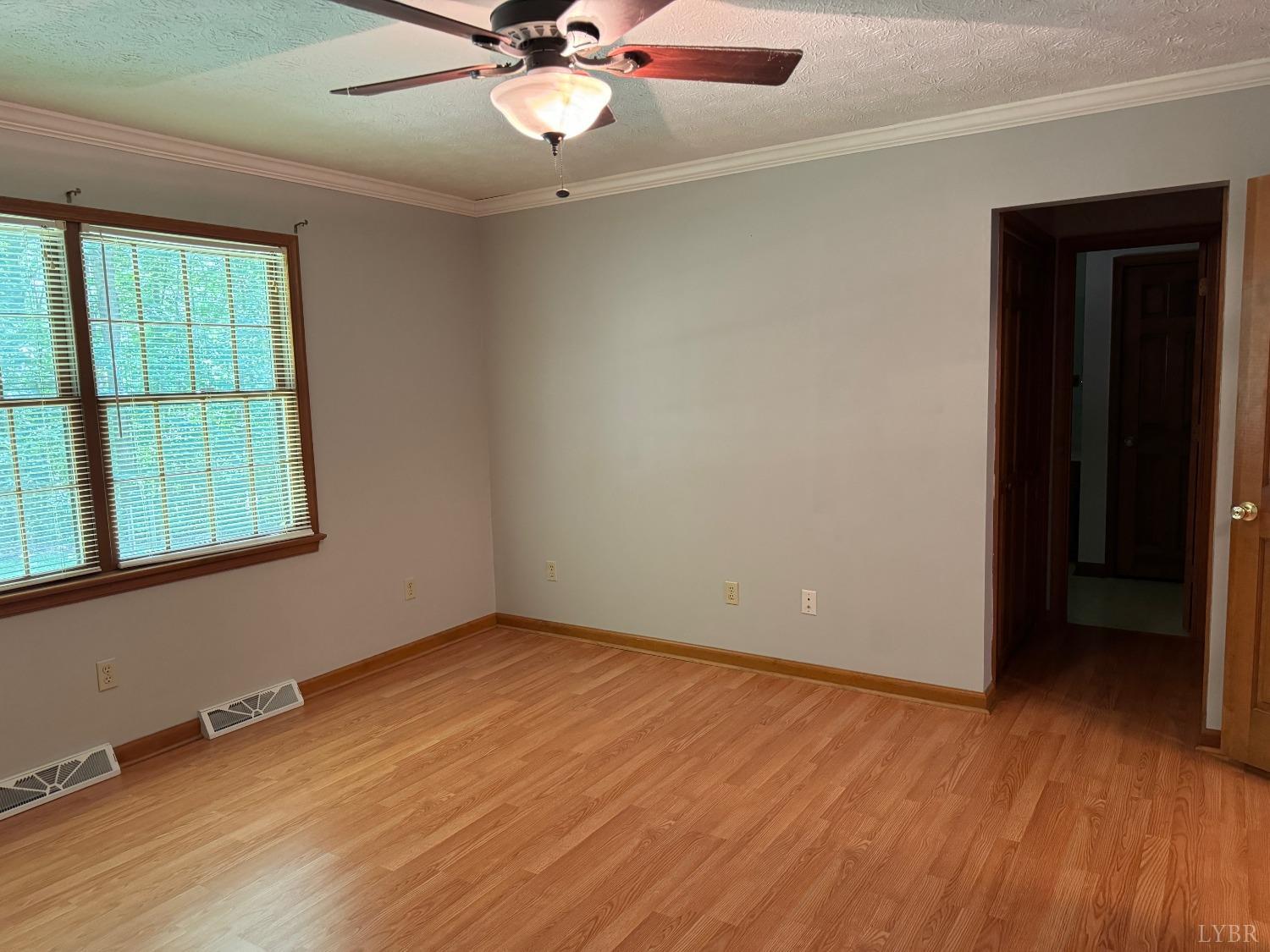 580 First Rock Road Prospect, VA 23960 - Photo 21 of 22 an empty room with wooden floor fan and windows