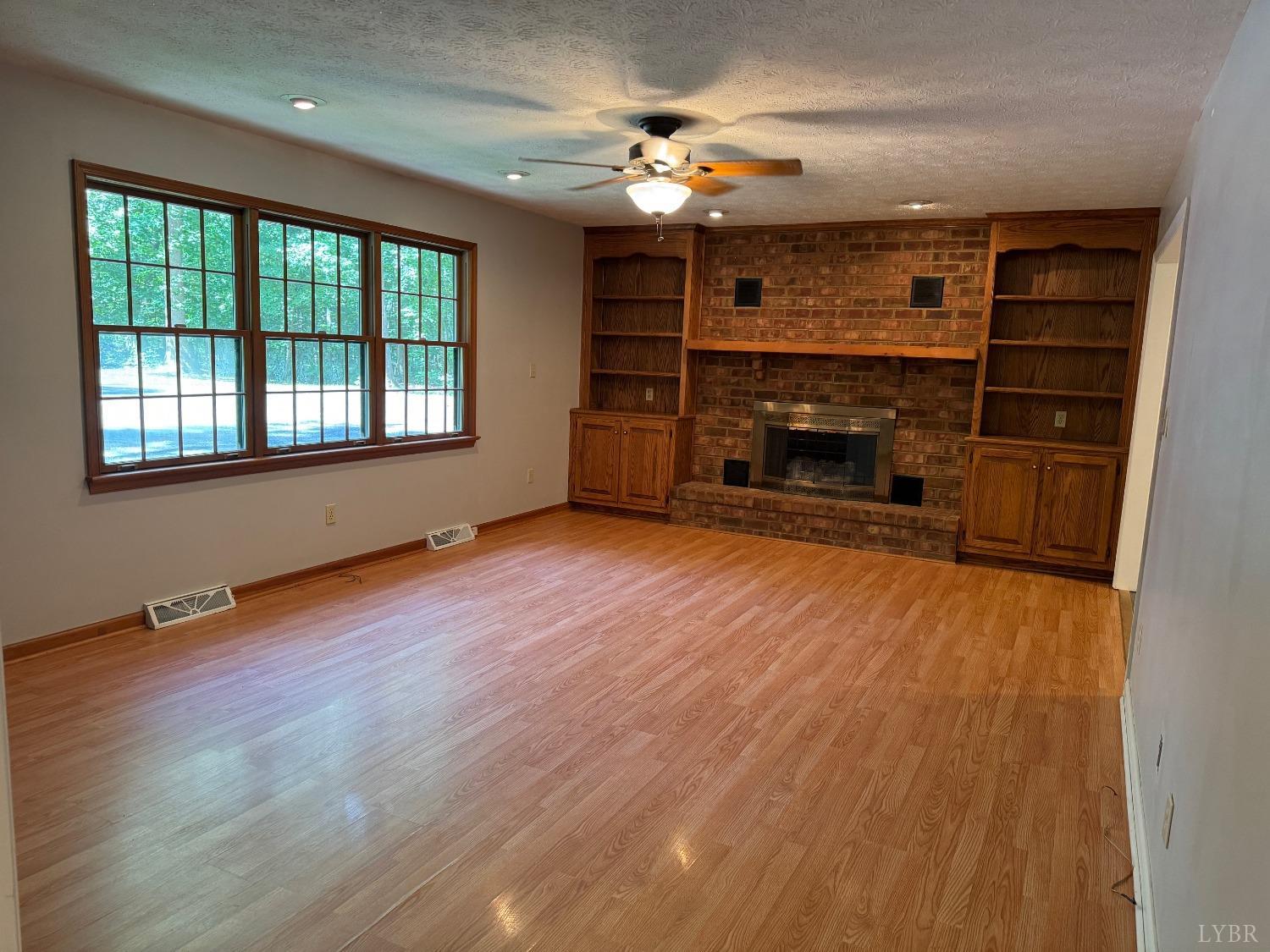 580 First Rock Road Prospect, VA 23960 - Photo 3 of 22 wooden floor in an empty room with a fireplace