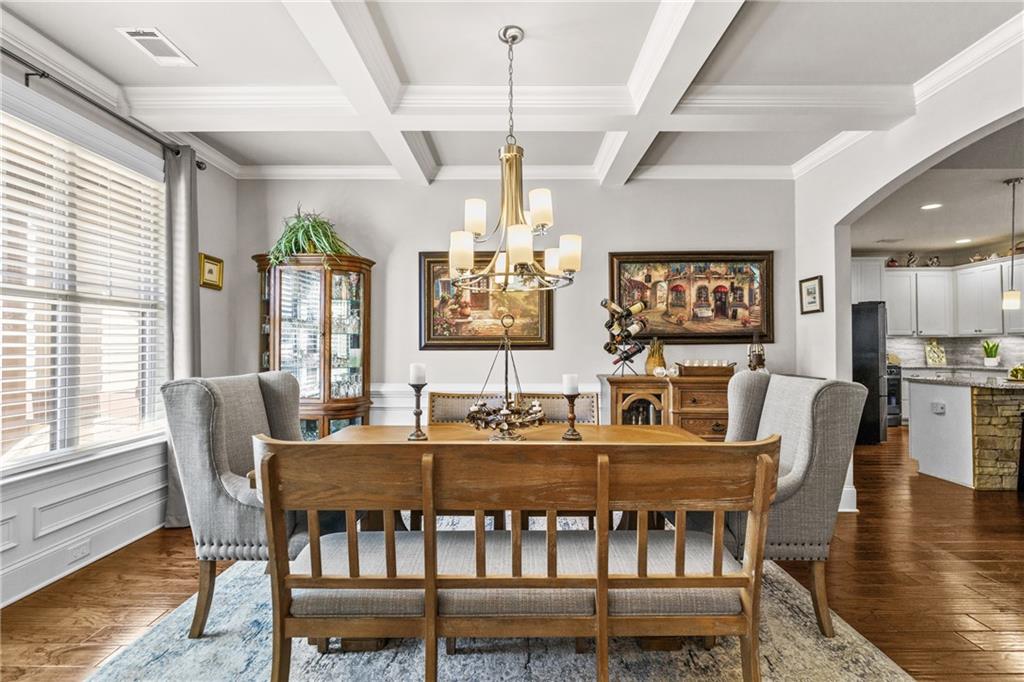 585 Hanover Drive Villa Rica, GA 30180 - Photo 12 of 72 a dining room with furniture a chandelier and wooden floor