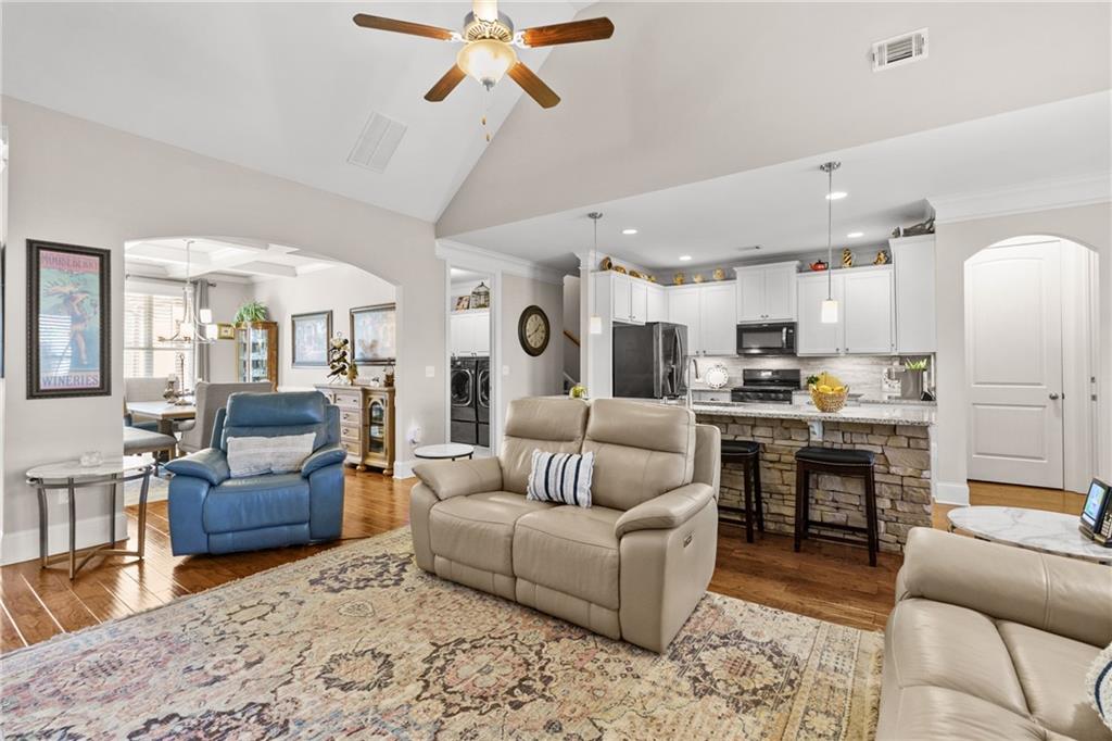 585 Hanover Drive Villa Rica, GA 30180 - Photo 21 of 72 a living room with furniture kitchen view and a wooden floor