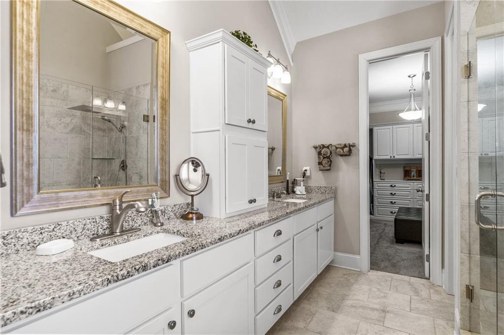 585 Hanover Drive Villa Rica, GA 30180 - Photo 28 of 72 a bathroom with a granite countertop sink mirror and shower