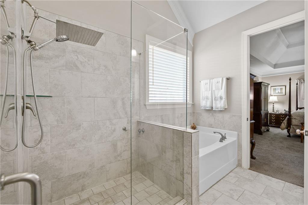 585 Hanover Drive Villa Rica, GA 30180 - Photo 29 of 72 a bathroom with a bathtub and a shower