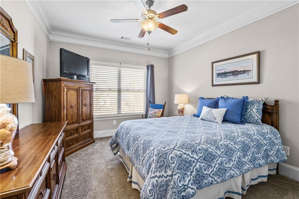 585 Hanover Drive Villa Rica, GA 30180 - Photo 32 of 72 a bedroom with a bed and wooden floor