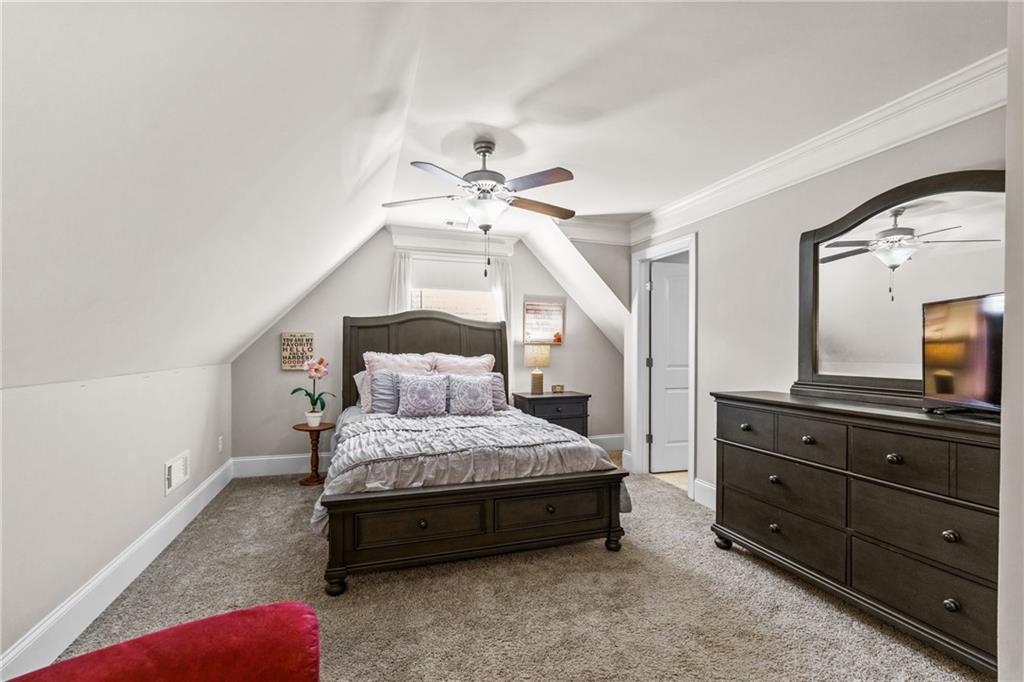 585 Hanover Drive Villa Rica, GA 30180 - Photo 38 of 72 a bedroom with a bed a chandelier and a dresser