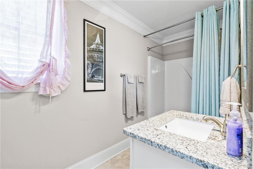 585 Hanover Drive Villa Rica, GA 30180 - Photo 40 of 72 a bathroom with a granite countertop sink a mirror and shower
