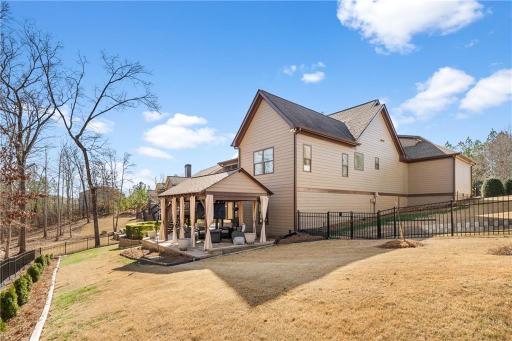 585 Hanover Drive Villa Rica, GA 30180 - Photo 52 of 72 a view of a white house with a yard and sitting area