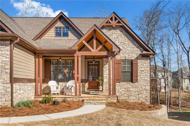 a dining room with furniture a chandelier and wooden floor