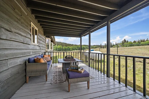 a balcony view with couple of couches and ocean view