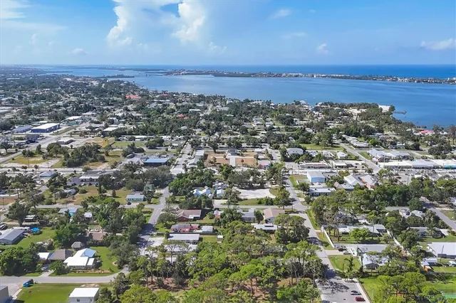 a view of a tennis ground with large trees