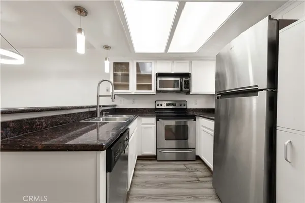 a kitchen with a refrigerator sink and stove top oven