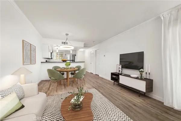 a living room with furniture a rug and a flat screen tv