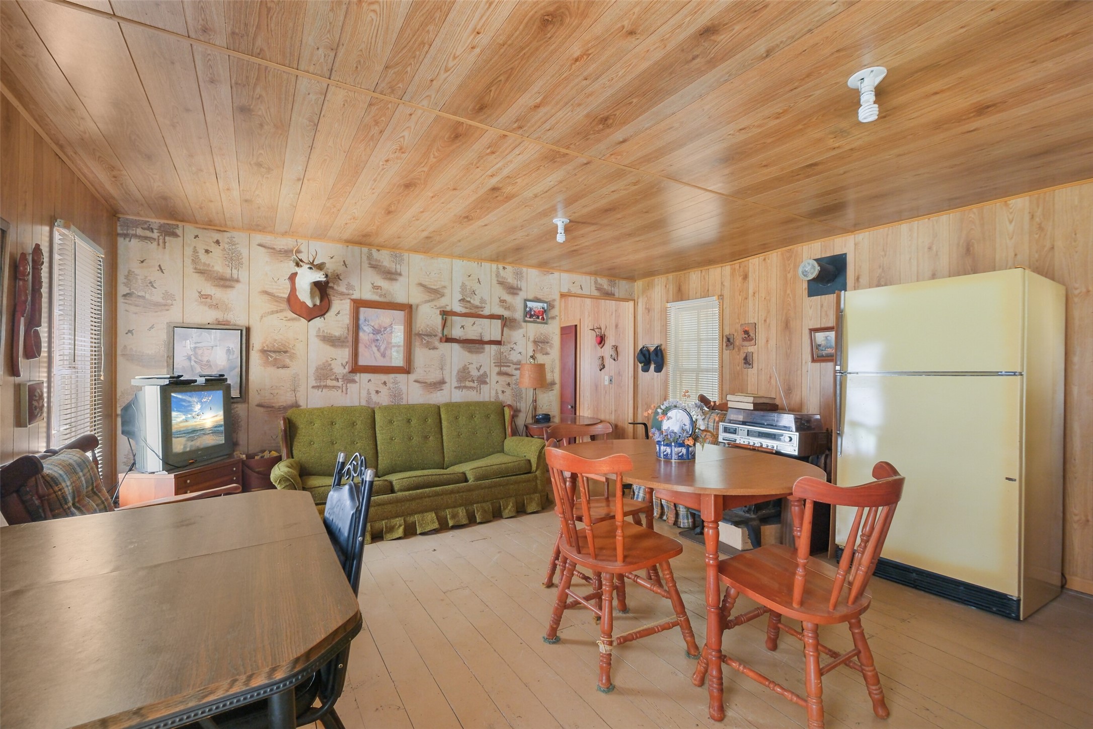 24718 Squirrel Road New Ulm, TX 78950 - Photo 18 of 26 a dining room with furniture and a refrigerator