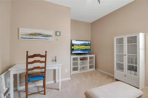 a living room with furniture and painting on the wall