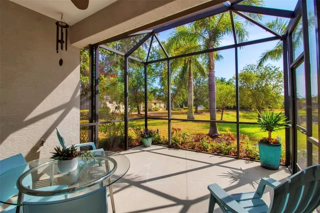 a view of living room with a floor to ceiling window and potted plants