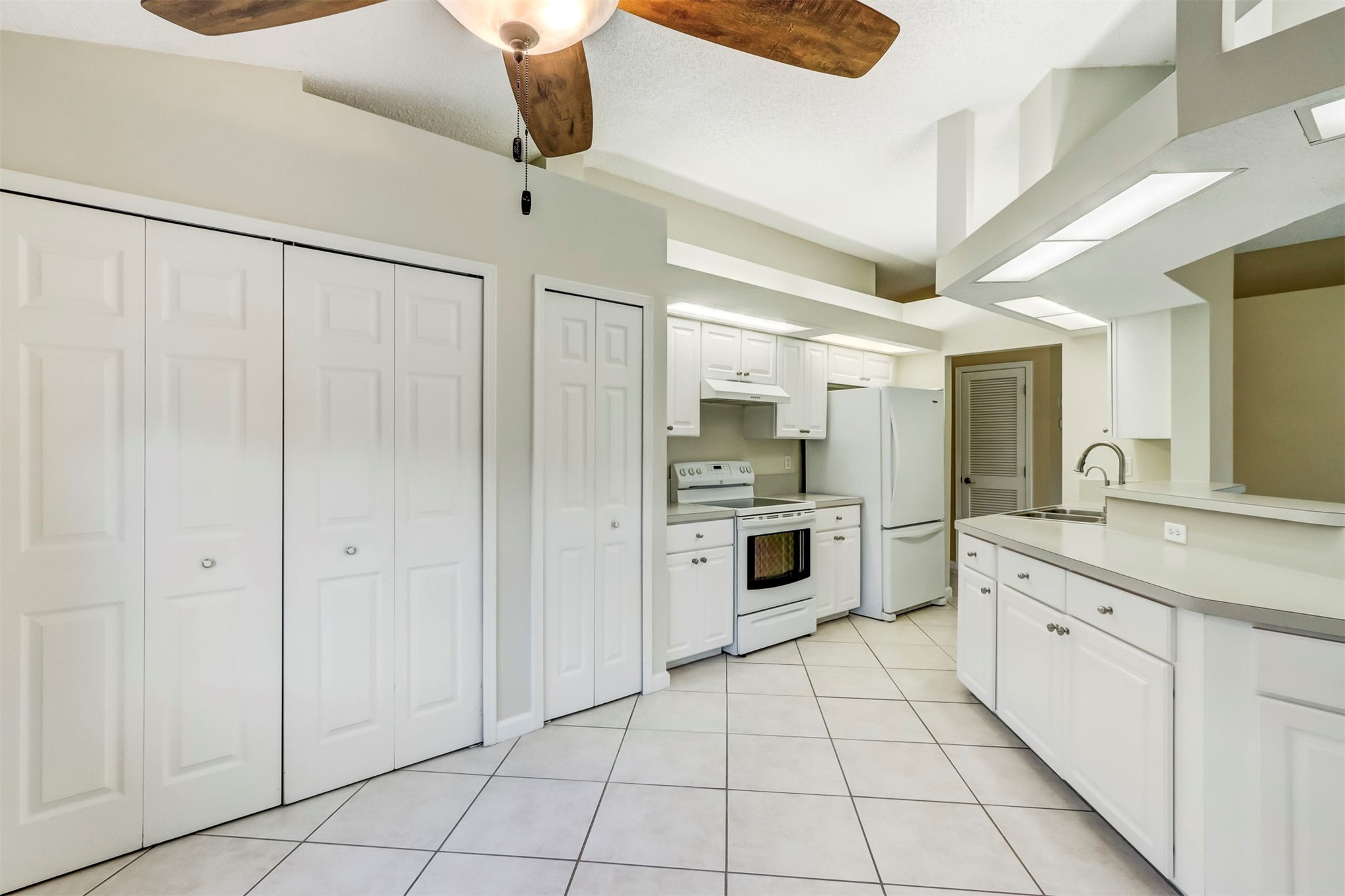 2415 Will Hardee Road Fernandina Beach, FL 32034 - Photo 20 of 59 a large white kitchen with cabinets a sink and appliances