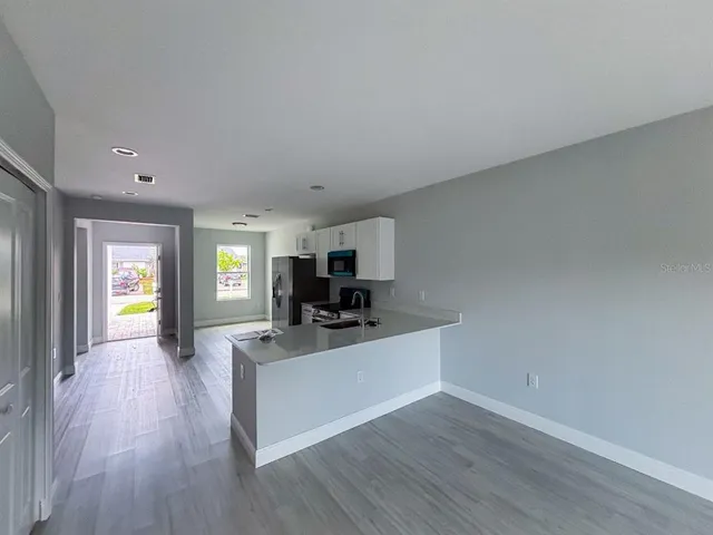 a living room with a couch and a chandelier