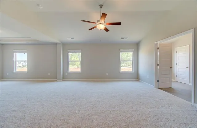 a view of a livingroom with a window and a ceiling fan