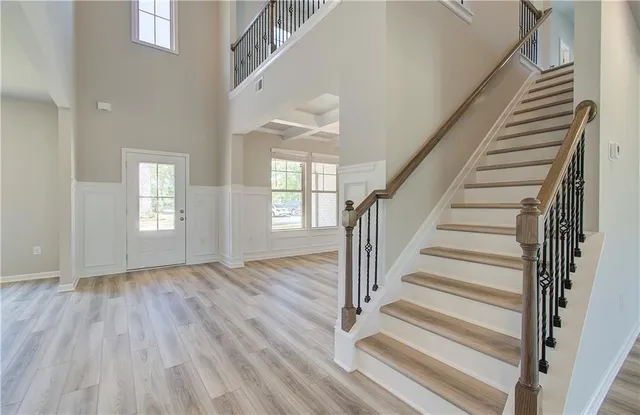 a view of entryway with wooden floor and front door