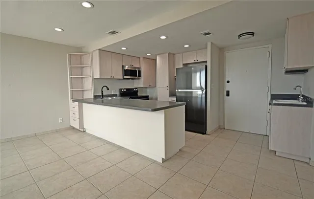 a kitchen with stainless steel appliances granite countertop a refrigerator sink and cabinets